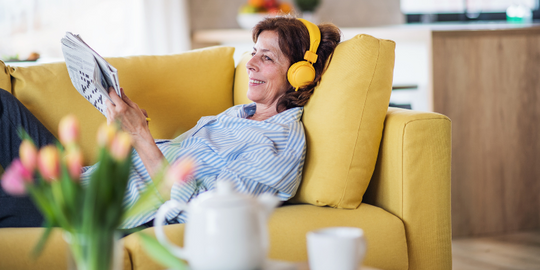 Menopausal woman listening to podcast