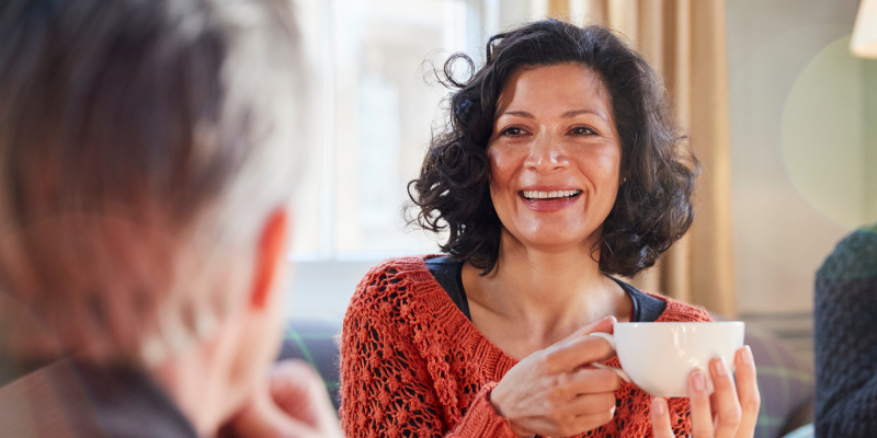 Middle aged woman smiling and talking about menopause