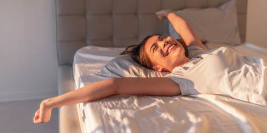 Natural women lying in bed smiling after orgasm