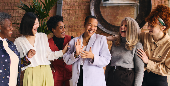 Diverse group of women smiling and laughing together