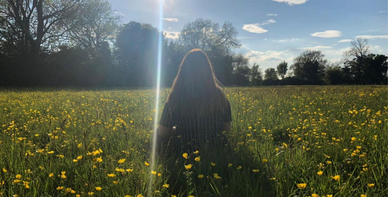 Sophie Claus sat in sunny meadow