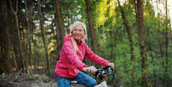 Mature women smiling and cycling