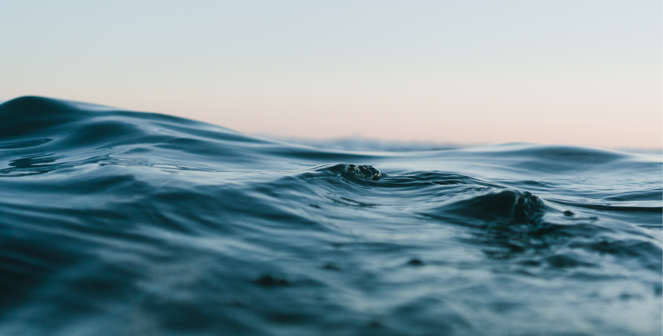 Ocean waves against sunset background