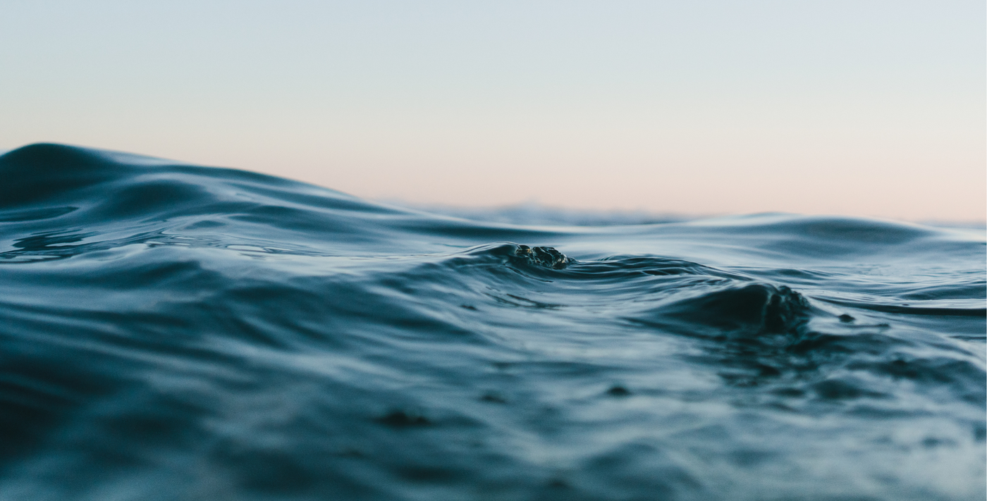 Ocean waves against sunset background