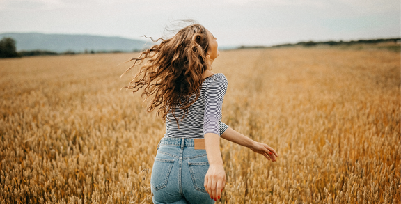 Woman running carefree through a field