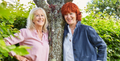 Susi Lennox and Sarah Brooks, founders of YES stand in an English garden next to a tree